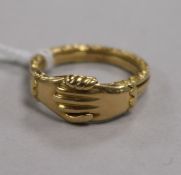 An antique yellow metal gimmel or fede ring, formed of three interlocking scroll-carved hoops with