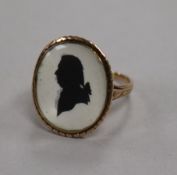 A Georgian style yellow metal oval silhouette ring, decorated with the bust of a gentleman to