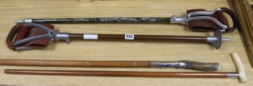 Four assorted walking sticks longest 107cm