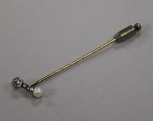 An early 20th century yellow metal, diamond and cultured pearl set stick pin, 74mm.