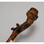 A carved wooden walking stick, with figural handle height 89cm