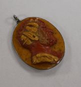 A 19th century red and yellow layered hardstone cameo carved with the head of a satyr, in pendant