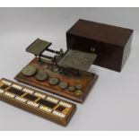 A set of Victorian postal scales and weights, a cribbage board and a tea caddy