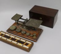 A set of Victorian postal scales and weights, a cribbage board and a tea caddy