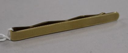 An engine-turned yellow metal tie clip (tests as 14ct), 11.1g