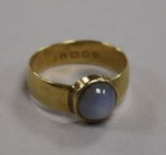 An 18ct gold and cabochon star sapphire ring, collet-set, size O.