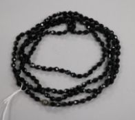 A single strand facet cut jet bead necklace, 139cm.