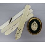 Four ivory or bone page turners and an Indian ivory pendant (framed)