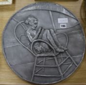 A pewter effect roundel by Peter Ryder