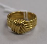 A yellow metal 'knot' ring (tests as 18ct), size O, 8.8g