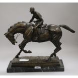 A bronze model of a jockey and horse height 34cm width 30cm