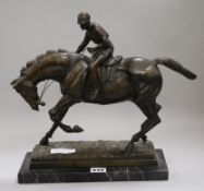 A bronze model of a jockey and horse height 34cm width 30cm