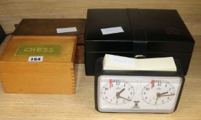 A weighted club-size chess set, two other boxed chess sets and a chess clock
