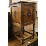 A carved oak bedside cupboard W.42cm