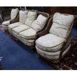 A 1930's three piece parcel gilt walnut double caned bergere suite settee W.190cm