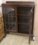 An oak two door leaded glazed bookcase W.92cm