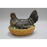 A Continental porcelain 'hen' basket and cover