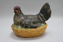 A Continental porcelain 'hen' basket and cover