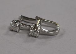 A pair of 18ct white gold and solitaire diamond ear studs.