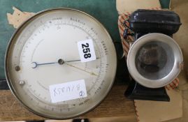 A brass aneroid barometer and twin thermometer and a three stars cycle lamp