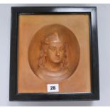 A terracotta portrait plaque in ebonised frame height 27cm width 25cm
