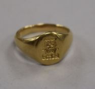 An 18ct yellow gold signet ring, with lion's head crest over crown, inscribed and dated 1927, size