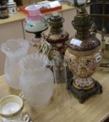 Two pottery oil lamps and a painted glass oil lamp tallest 41cm