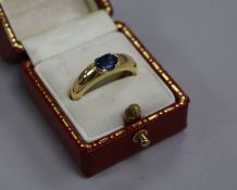 An 18ct gold and oval-cut sapphire solitaire ring, size N.