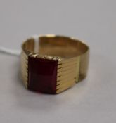 A yellow metal signet ring with blank red stone matrix (tests as 9ct gold), 6.2g