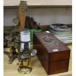 A Smith & Beck brass microscope, a bull's-eye condenser oil lamp, and a R & J Beck microscope and