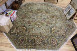 A Persian green ground octagonal carpet W.244 x 244cm