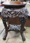 A pair of 19th century Chinese carved hardwood jardiniere stands