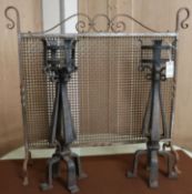 A pair of wrought iron firedogs and a firescreen W.85cm