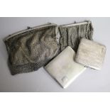 Two silver cigarette cases and two white metal mesh evening purses.