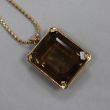 A continental yellow metal mounted smoky quartz pendant, on an 18ct gold chain, pendant 29mm.