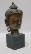 A bronze bust of a Buddha on stand height 26cm