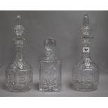 A pair of Victorian cut glass decanters and stoppers and another