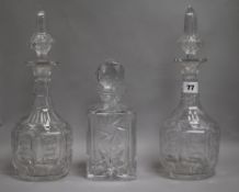 A pair of Victorian cut glass decanters and stoppers and another