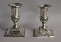 A pair of Edwardian silver dwarf candlesticks, London, 1901, weighted, 10.5cm.