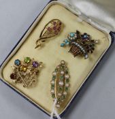 Three 9ct gold and gem set brooches and a yellow metal and gem set brooch, including two floral