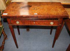 A George III oak tea table with folding top W.77cm