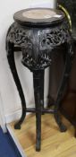 A Chinese carved hardwood marble inset jardiniere stand W.35cm