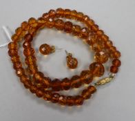 A single strand facetted amber bead necklace and a pair of matching earrings.