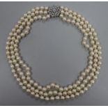 A triple strand cultured pearl necklace with 14ct white gold diamond cluster clasp, approx. 52cm.