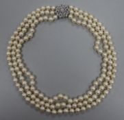 A triple strand cultured pearl necklace with 14ct white gold diamond cluster clasp, approx. 52cm.