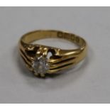 An Edwardian 18ct gold and claw set solitaire diamond ring, size K.
