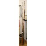 Four sea fishing rods and three reels