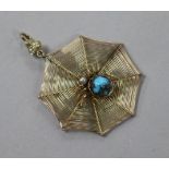 An early 20th century yellow metal spider's web pendant with gem set spider and diamond set bale,