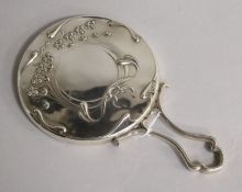 An Edwardian Art Nouveau silver hand mirror with loop handle, Mappin Bros. London, 1902, 22.5cm.