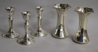 A pair of George V silver spill vases, London, 1911 and a set of three later silver dwarf
